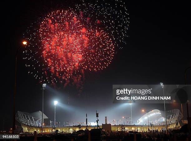 Fireworks explode over the newly built national stadium during the opening ceremony of the 25th Southeast Asian Games in Vientiane on December 9,...