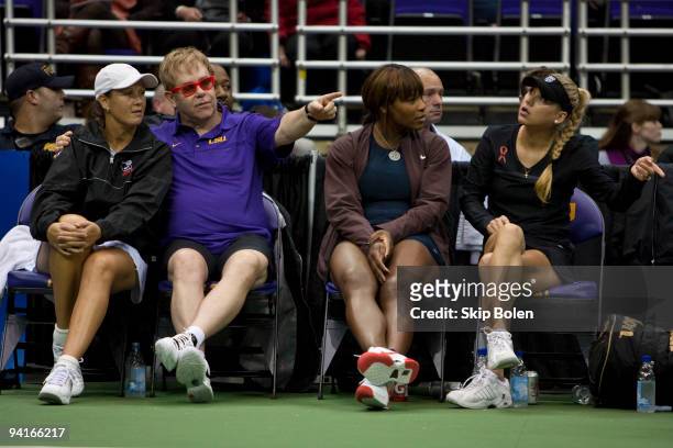 Liezel Huber, Sir Elton John, Serena Williams and Anna Kournikova watch a mixed doubles match from the court side at the 17th Annual World Team...