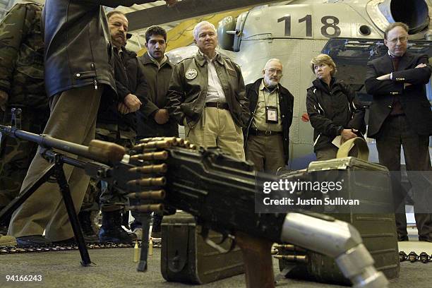 Secretary of Defense Robert Gates looks at a weapons display while meeting with members of coalition military at a NATO aviation training facility at...