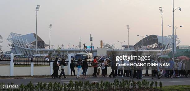 Lao people line up to enter the newly built national stadium to attend the opening ceremony of the 25th Southeast Asian Games in Vientiane on...