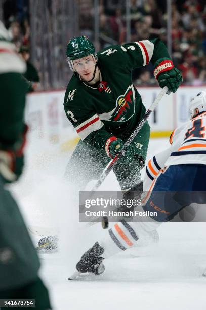 Charlie Coyle of the Minnesota Wild passes the puck away from Zack Kassian of the Edmonton Oilers during the game on April 2, 2018 at Xcel Energy...