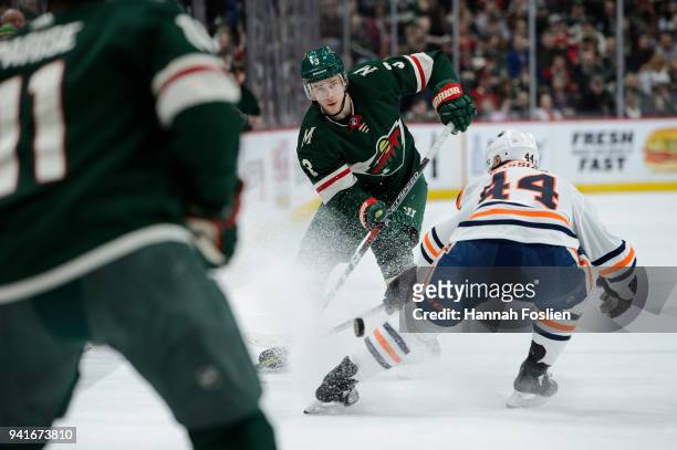 Charlie Coyle of the Minnesota Wild passes the puck away from Zack Kassian of the Edmonton Oilers during the game on April 2, 2018 at Xcel Energy...