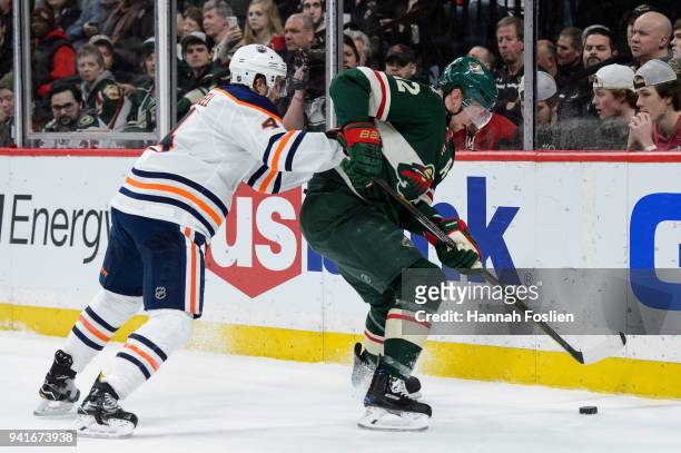 Eric Staal of the Minnesota Wild controls the puck against Kris Russell of the Edmonton Oilers during the game on April 2, 2018 at Xcel Energy Center...