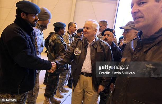 Secretary of Defense Robert Gates greets members of coalition military while visiting a NATO aviation training facility at Kabul International...