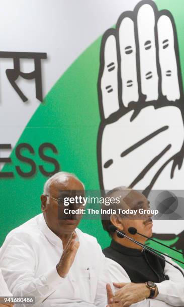 Congress Party leaders Mallikarjun Kharge with Ghulam Nabi Azad during a press conference against BJP government at AICC in New Delhi.