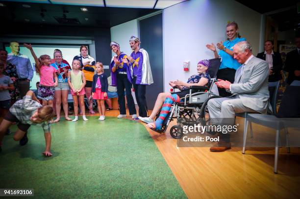 Prince Charles, Prince of Wales sits with Abbi Head-13 of Brisbane during an official visit to the Lady Cilento Children's Hospital on April 4...
