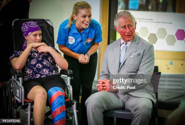 Prince Charles, Prince of Wales sits with Abbi Head-13 of Brisbane during an official visit to the Lady Cilento Children's Hospital on April 4...