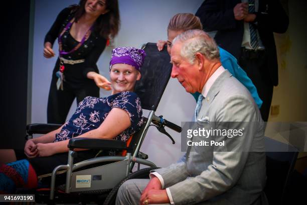 Prince Charles, Prince of Wales sits with Abbi Head-13 of Brisbane during an official visit to the Lady Cilento Children's Hospital on April 4...