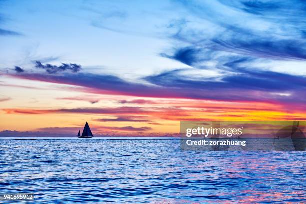 sailboat sailing during at sunset, hawaii - kailua beach stock pictures, royalty-free photos & images