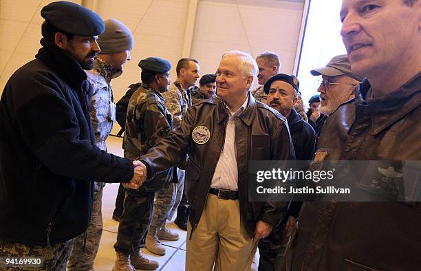 Secretary of Defense Robert Gates greets members of coalition military while visiting a NATO aviation training facility at Kabul International...