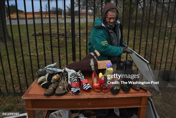 Floyd Wilson Jr. Has set up yard sale table just outside the black wrought-iron fence that surrounds the campus of St. Elizabeths Hospital on MLK...