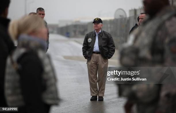 Secretary of Defense Robert Gates stands in the middle of the road while visiting Kabul International Airport December 9, 2009 in Kabul, Afghanistan....