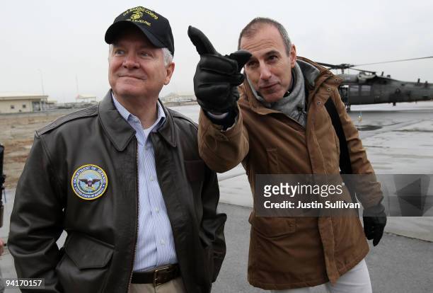 Secretary of Defense Robert Gates looks on while Today Show host Matt Lauer gestures while visiting Kabul International Airport December 9, 2009 in...