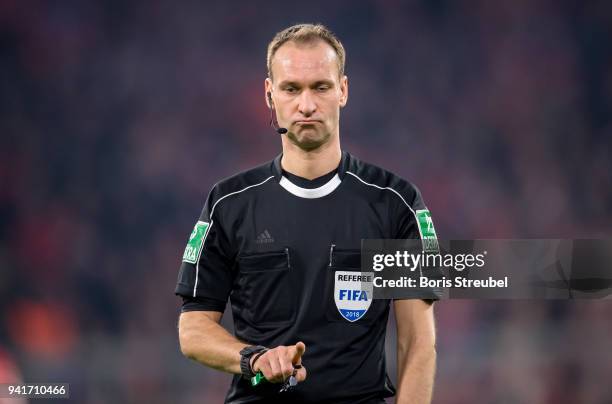 Referee Bastian Dankert gestures during the Bundesliga match between FC Bayern Muenchen and Borussia Dortmund at Allianz Arena on March 31, 2018 in...