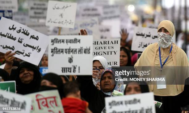 Indian Muslim women take part in a protest against the "triple talaq bill" in New Delhi on April 4, 2018. Muslim women in India have gathered to...