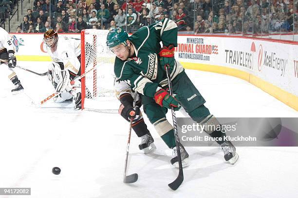 Chuck Kobasew of the Minnesota Wild handles the puck with Joffrey Lupul of the Anaheim Ducks closely defending during the game at the Xcel Energy...