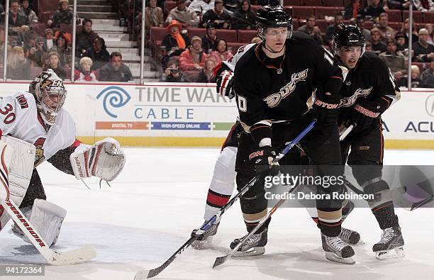 Brian Elliott of the Ottawa Senators defends in the crease against Corey Perry and Joffrey Lupul the Anaheim Ducks during the game on December 6,...