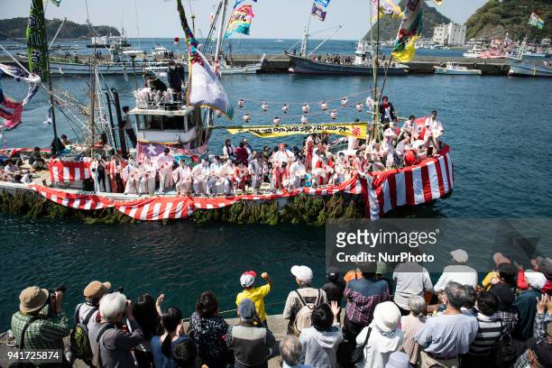 Boat load of dancing fishermen with their faces powdered white and dressed with women's robes took center stage at the Uchiura fishing port during...