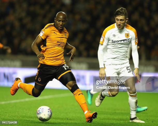 Benik Afobe of Wolverhampton Wanderers controls the ball watched by Angus MacDonald during the Sky Bet Championship match between Wolverhampton...