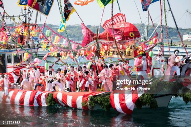 Boat load of dancing fishermen with their faces powdered white and dressed with women's robes took center stage at the Uchiura fishing port during...