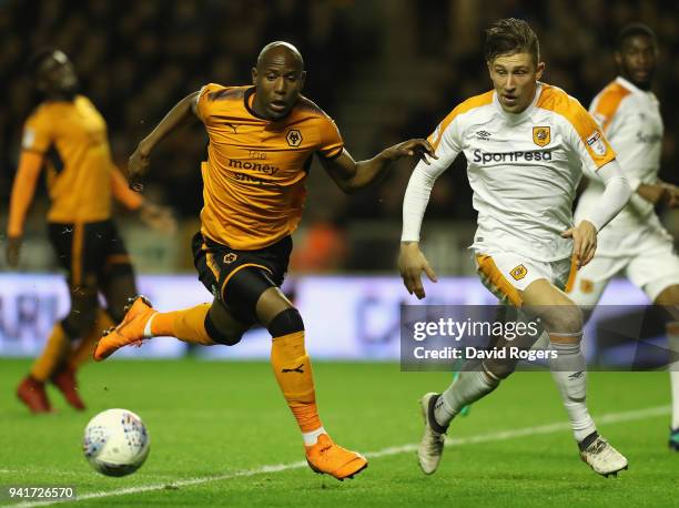 Benik Afobe of Wolverhampton Wanderers controls the ball watched by Angus MacDonald during the Sky Bet Championship match between Wolverhampton...