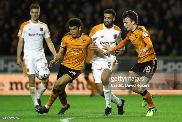 Morgan Gibbs-White of Wolves is challenged by Michael Hector as team mate Oskar Buur Rasmussen looks on during the Sky Bet Championship match between...