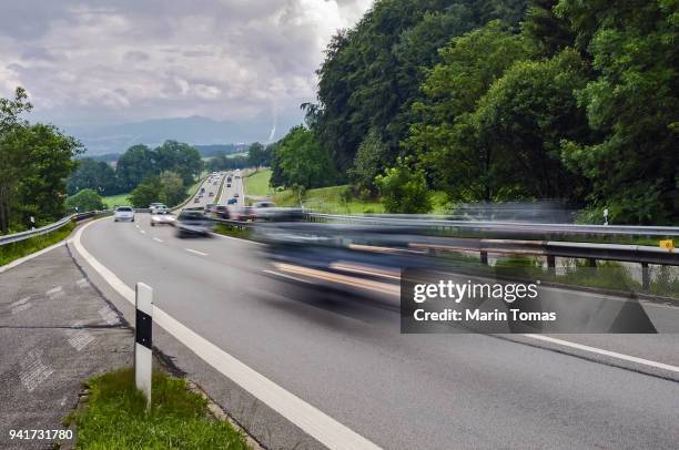 cars speeding on a highway - アウトバーン ストックフォトと画像