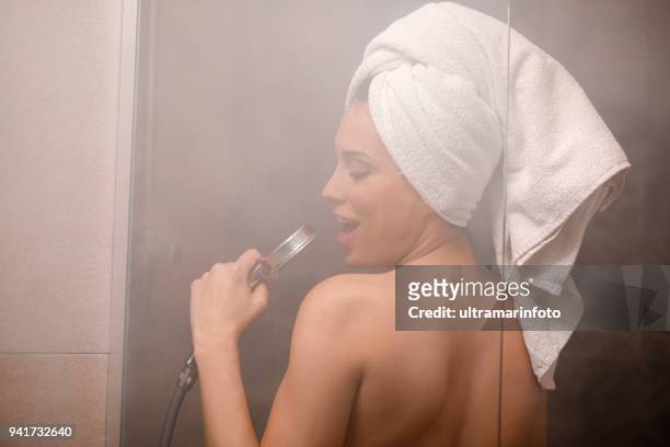 singing in the shower. natural beauty portrait beautiful young woman with a towel wrapped around her hair, after showering. in the bathroom. - singing shower stock pictures, royalty-free photos & images