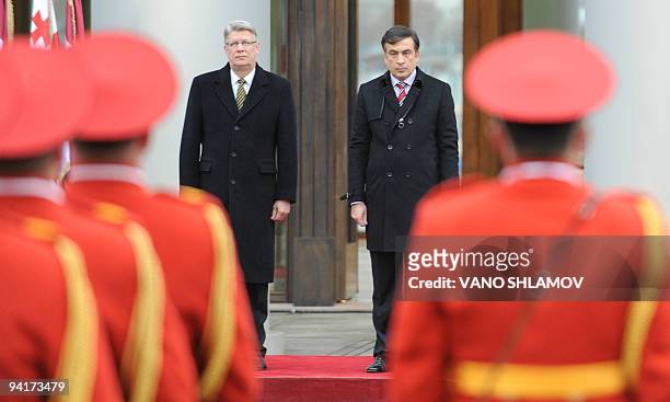 Georgian President Mikheil Saakashvili and his Latvian counterpart Valdis Zatlers inspect an honor guard in Tbilisi on December 8, 2009. Zatlers...