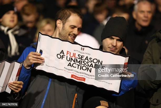 Fans of Fulham hold up a clapper advertising season tickets during the Sky Bet Championship match between Fulham and Leeds United at Craven Cottage...