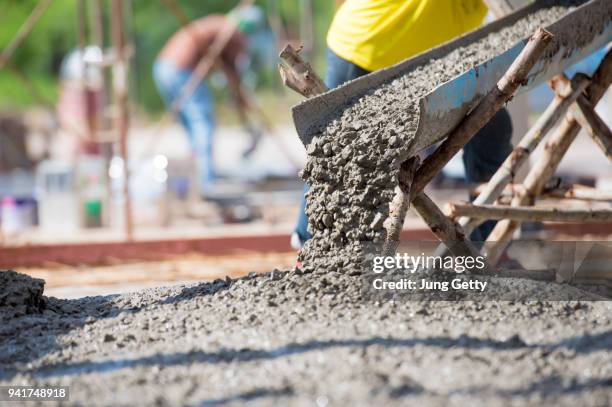 concrete pouring at construction site - cement construction stock pictures, royalty-free photos & images