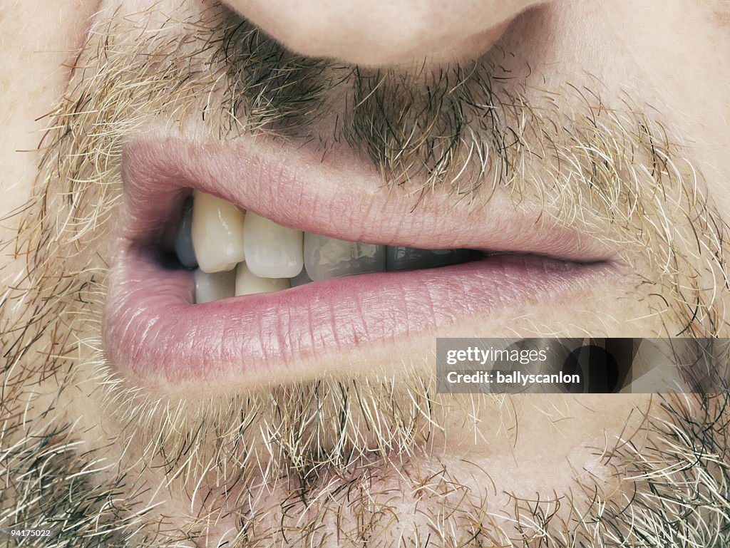 Bearded man snarling.