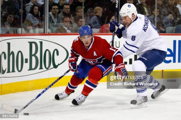 Mike Cammalleri of the Montreal Canadiens skates with the puck while being defended by Mike Komisarek of the Toronto Maple Leafs during the NHL game...