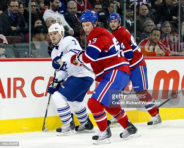 Ryan White of the Montreal Canadiens and Ian White of the Toronto Maple Leafs watch the puck in the corner during the NHL game on December 1, 2009 at...