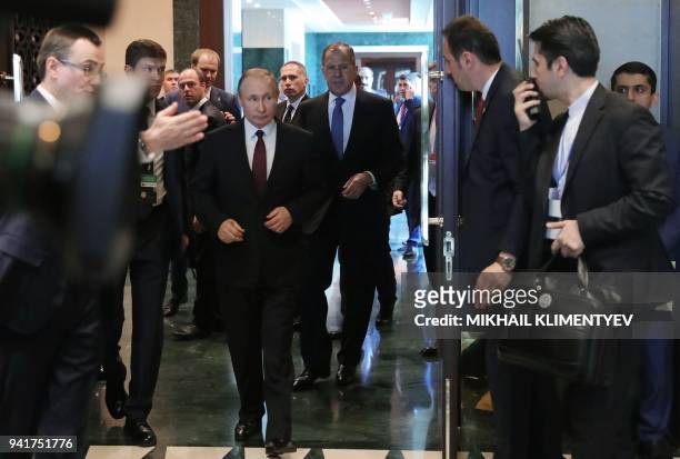 Russian President Vladimir Putin, accompanied by Foreign Minister Sergei Lavrov, enters a hall to meet Iranian President Hassan Rouhani in Ankara on...