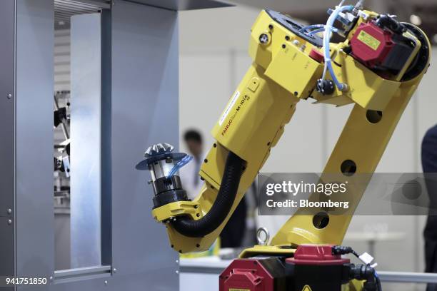 Fanuc Inc. Robotic arm demonstrates the AI system developed by Musashi Seimitsu Industry Co. And Abeja Inc. At the Artificial Intelligence Exhibition...