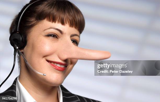 customer care - call centre woman telling lies - long nose ストックフォトと画像