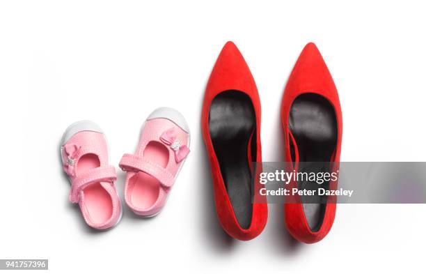 baby girl and adult woman's shoes - baby shoes stock-fotos und bilder