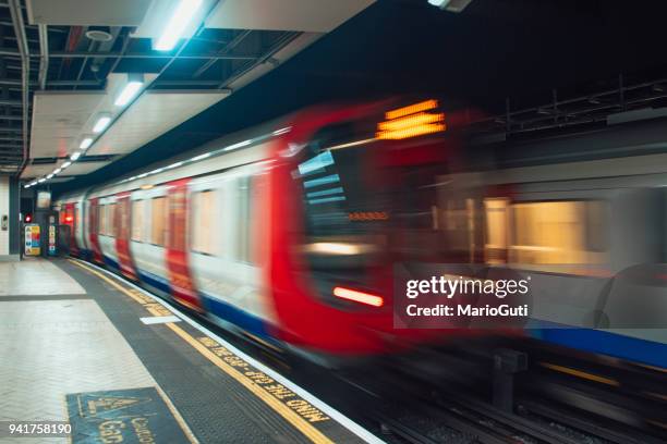 london underground train in motion - roundel stock pictures, royalty-free photos & images