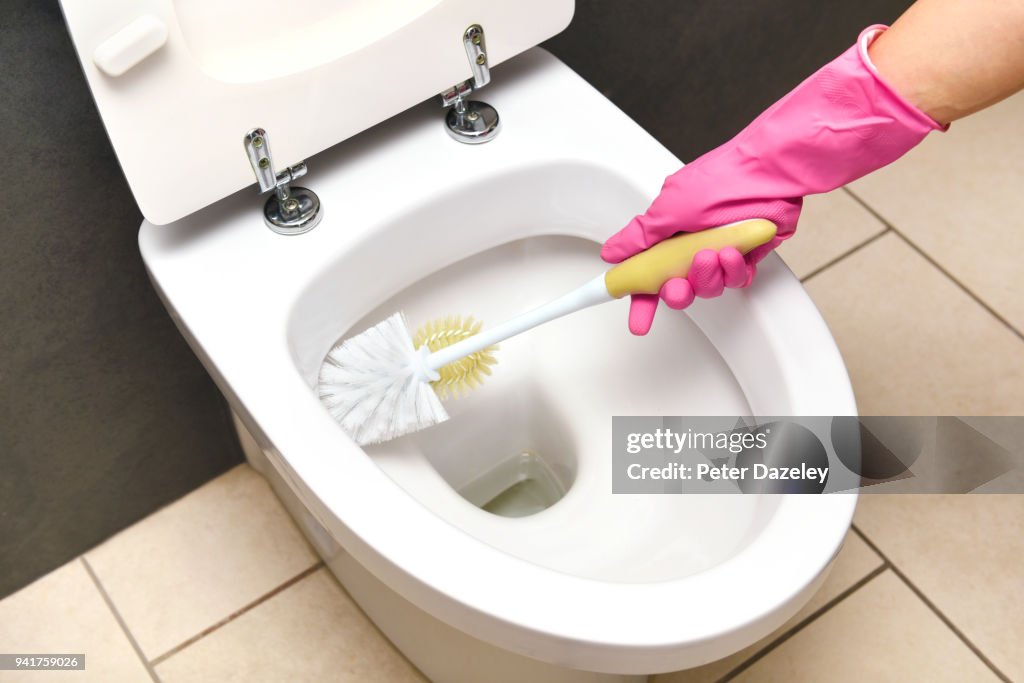 CLEANING TOILET WITH TOILET BRUSH