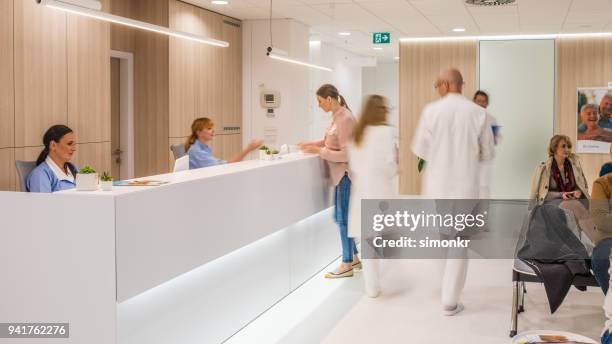 doctors walking in clinic - waiting room clinic stock pictures, royalty-free photos & images