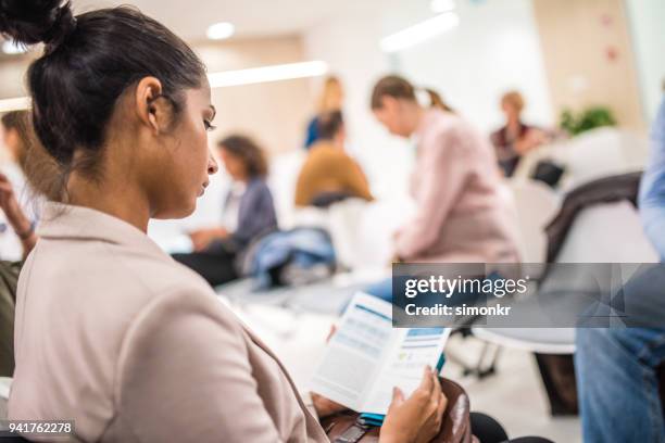 patient reading brochure - brochure stock pictures, royalty-free photos & images