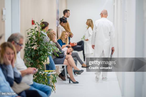 patiënten te wachten in de wachtkamer - patients in doctors waiting room stockfoto's en -beelden