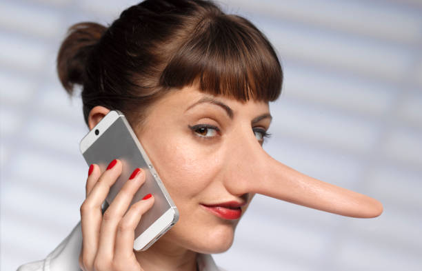 woman telling lies on mobile phone - private sale stock pictures, royalty-free photos & images