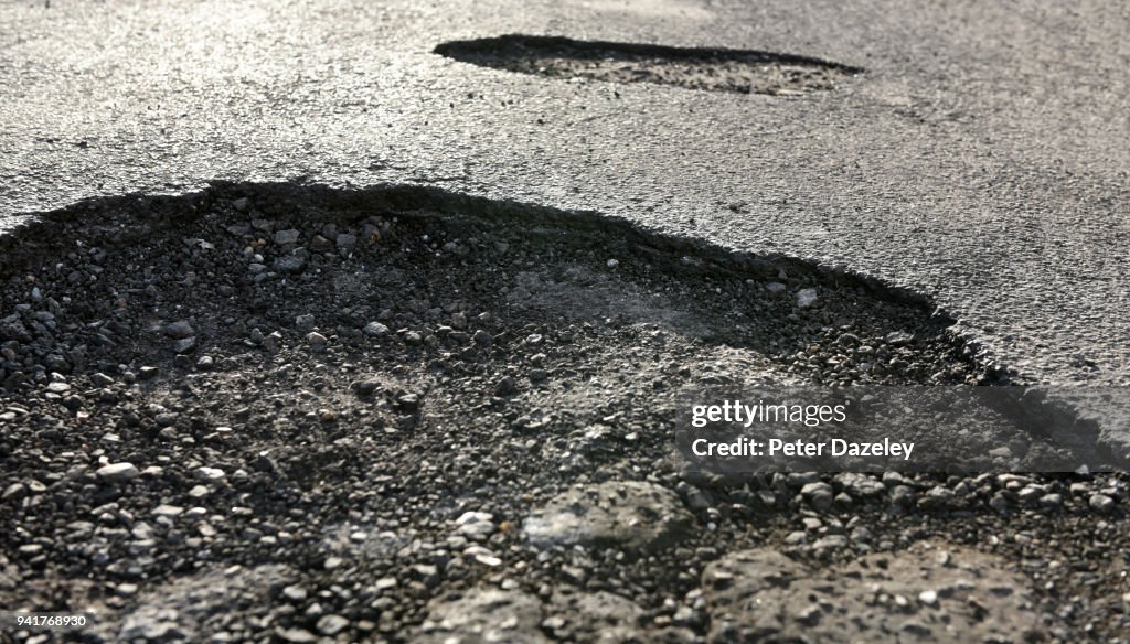 ROAD WITH DANGEROUS POTHOLES