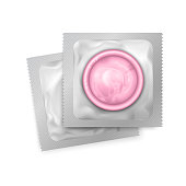 Realistic vector pink latex condoms in close up packing on white background. Contraceptive birth control and safe sex method.