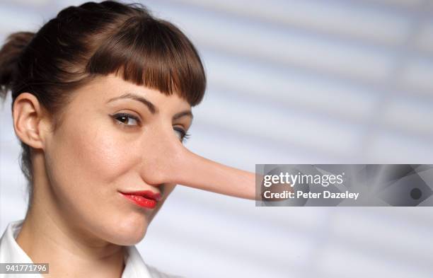 untrustworthy woman with long nose - truth lies foto e immagini stock