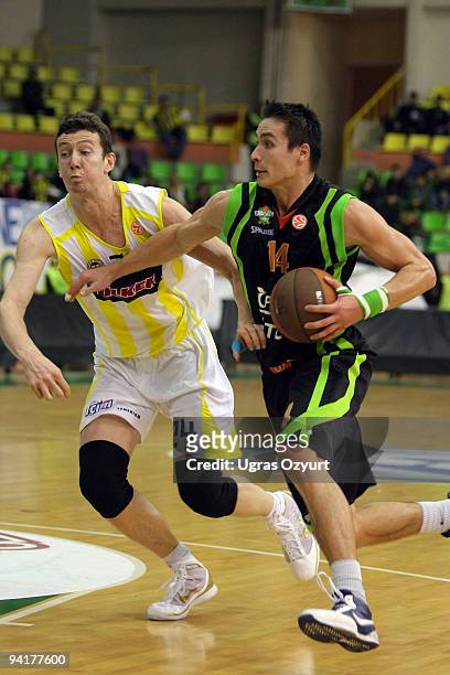 Kristjan Kangur, #14 of Asvel Basket Lyon Villeurbane competes with and Omer Asik, #24 of Fenerbahce Ulker Istanbul competes with in action during...