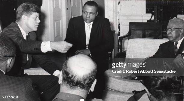President John F. Kennedy speaks with a group of business leaders, among them John H Sengstacke , publisher of the Chicago Daily Defender, and...