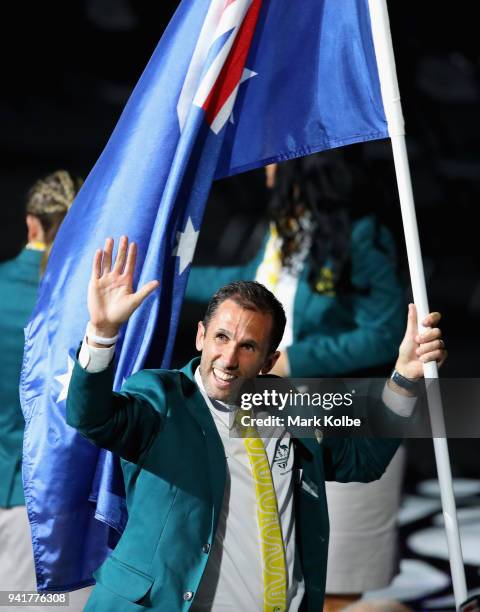 Mark Knowles, flag bearer of Australia arrives with the Australia team during the Opening Ceremony for the Gold Coast 2018 Commonwealth Games at...